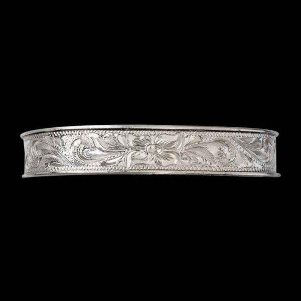 Our Dixie Western Cuff Bracelet adds a touch of Western Class to any outfit. Features hand engraved vines and flowers details on a natural finish german silver base. Order it now!